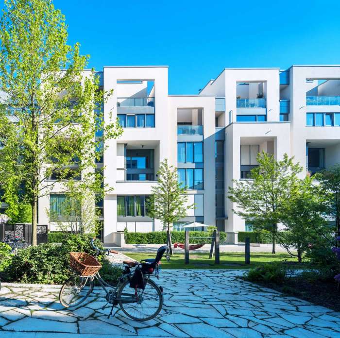 Modern housing behind a walking path and a parked bicycle