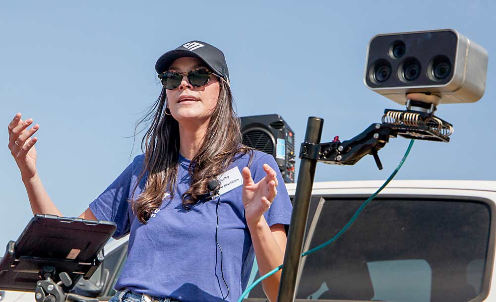 Shelby Greer of Vivid Machines talks about her company’s sensor technology during the Crop Load Management Technology Field Day in July at the Washington State University Sunrise Research Orchard near Wenatchee. 