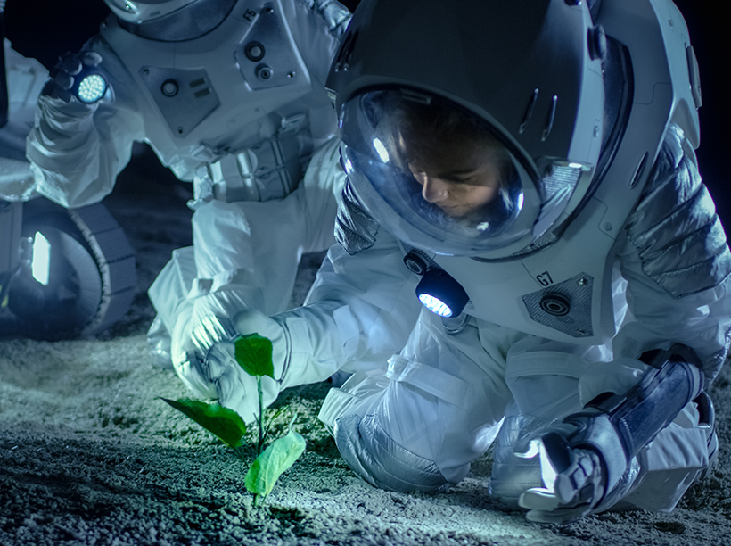 Astronaut in space planting vegetation  