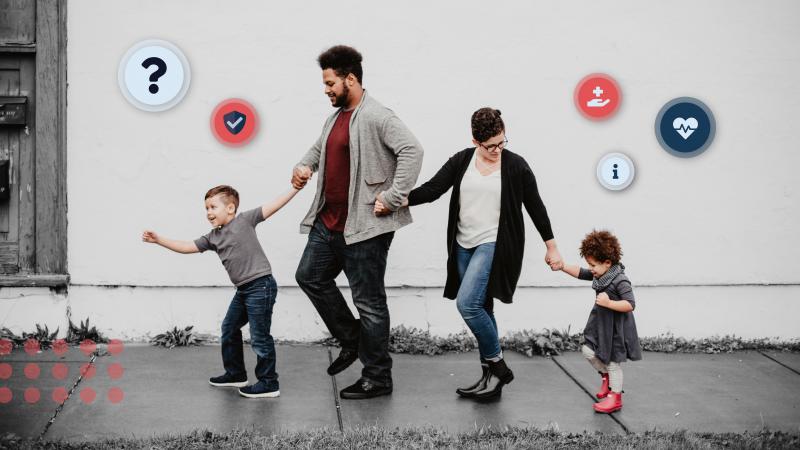 family of four walking and holding hands