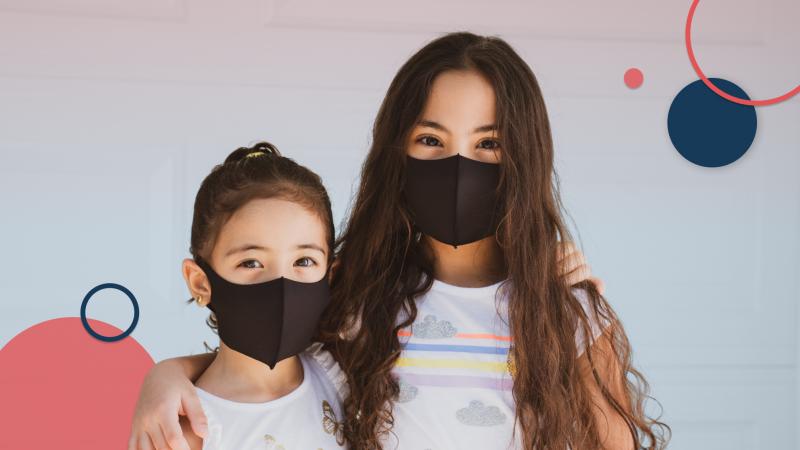 two children wearing black face masks 