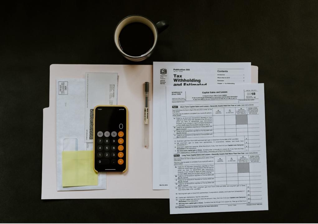 A calculator and papers on a table 
