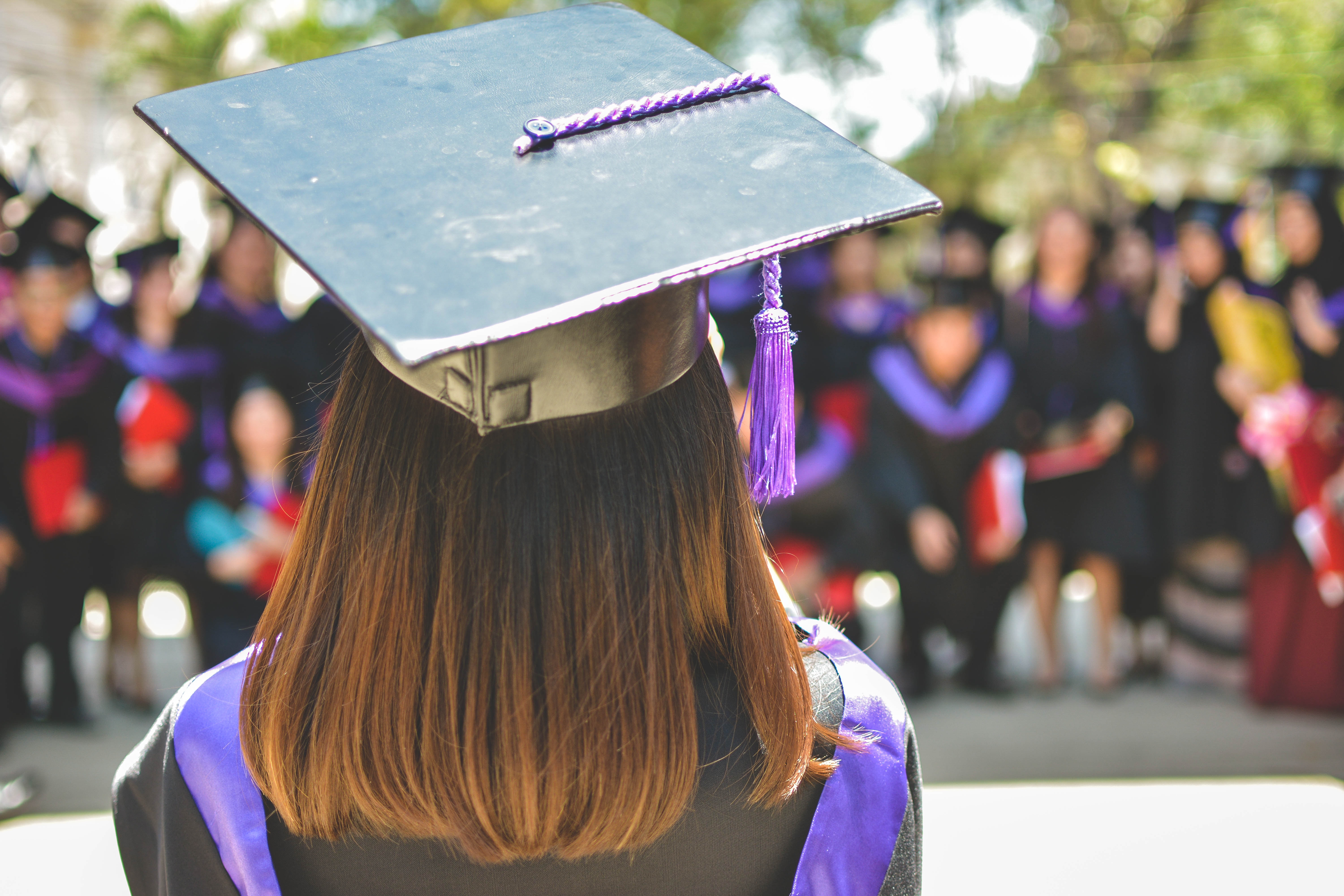 back view of female student's head in graduation clothing