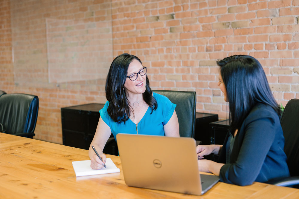 two women chatting during a job onboarding session